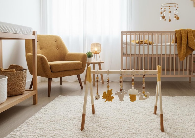 May include: A nursery scene with a wooden baby play gym featuring hanging toys, a crib, and a mustard-colored armchair. The room has a neutral color palette with a white rug and curtains.