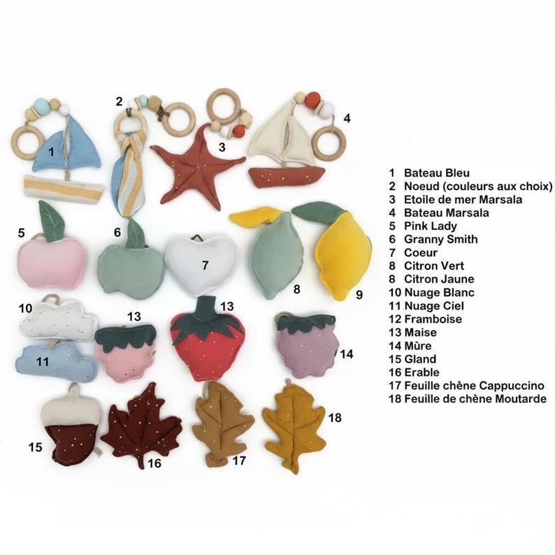 May include: A collection of colorful felt shapes, including a blue sailboat, a red starfish, a pink apple, a green apple, a white heart, a yellow lemon, a strawberry, and leaves. Each shape has a wooden ring.