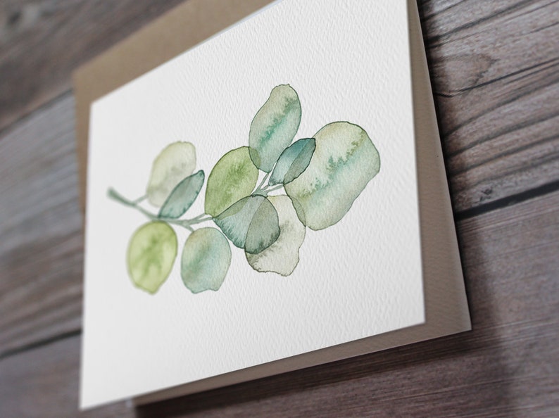 May include: A watercolor painting of a eucalyptus branch with green leaves. The leaves are painted in a light and airy style, with a soft, watercolor effect.