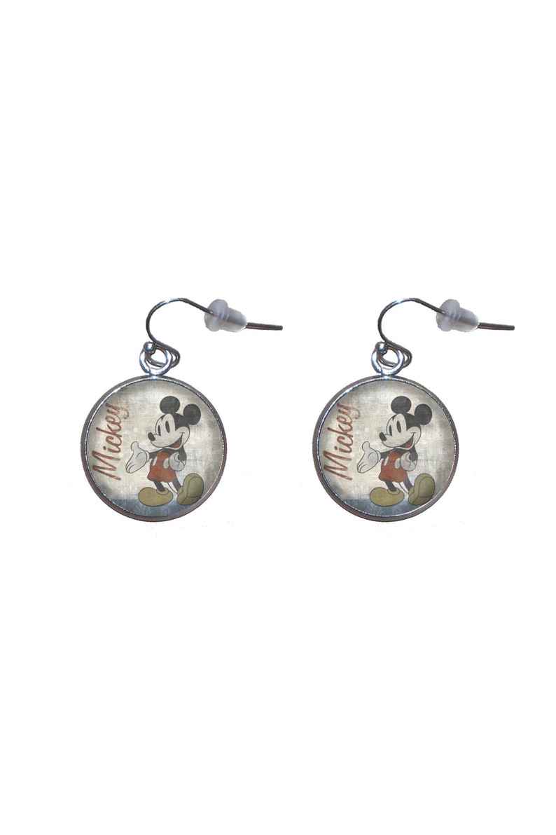 May include: A pair of silver dangle earrings with round, silver-rimmed charms featuring a vintage image of Mickey Mouse with the word "Mickey" printed on the charm.