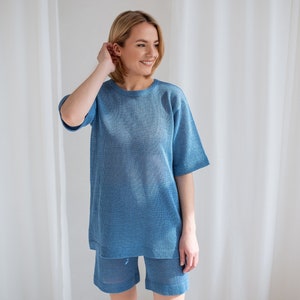 Minimalist, see-through linen blouse in light blue. Comfortable, sophisticated fit for every summer occasion.