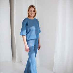 Knitted linen blouse in light blue. Paired with wide-leg pants