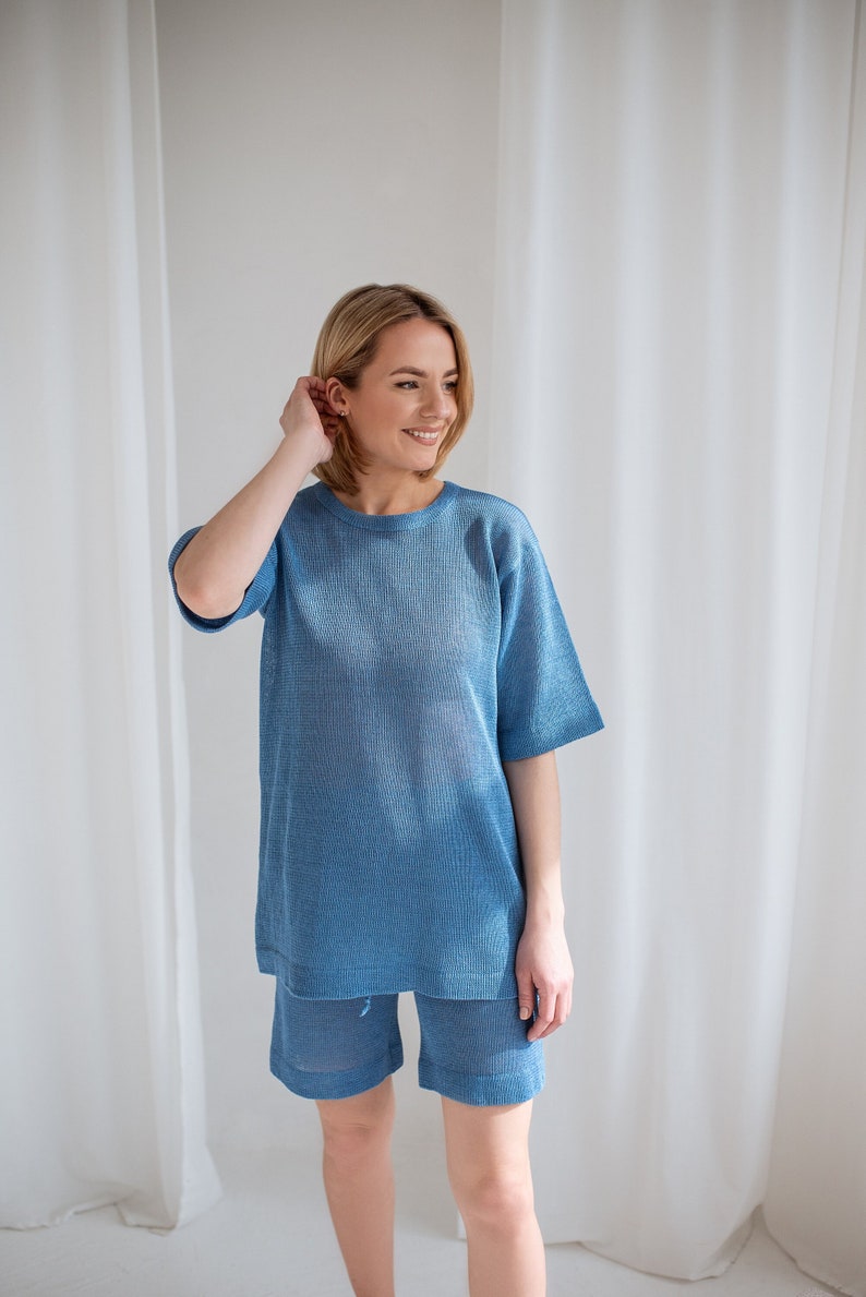 Minimalist, see-through linen blouse in light blue. Comfortable, sophisticated fit for every summer occasion.