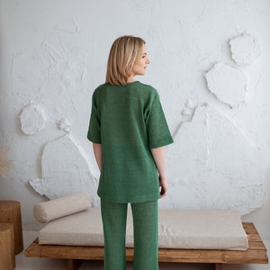 Minimalist, see-through linen blouse in green. Comfortable, sophisticated fit for every summer occasion.