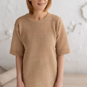 Beige knitted blouse.