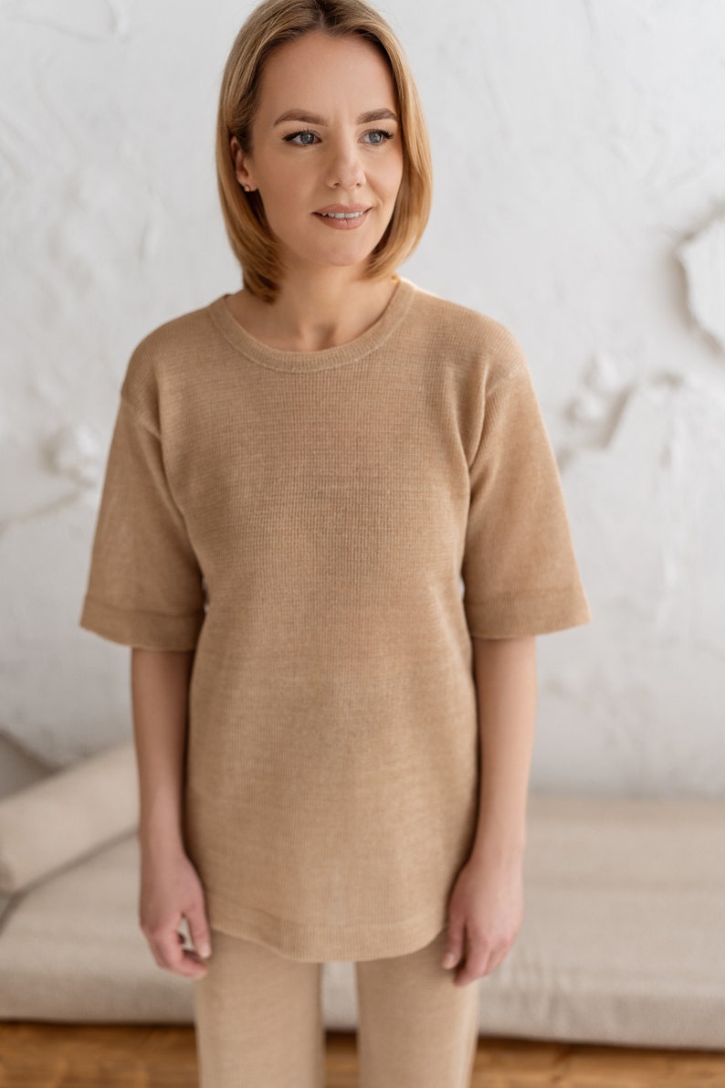 Beige knitted blouse.