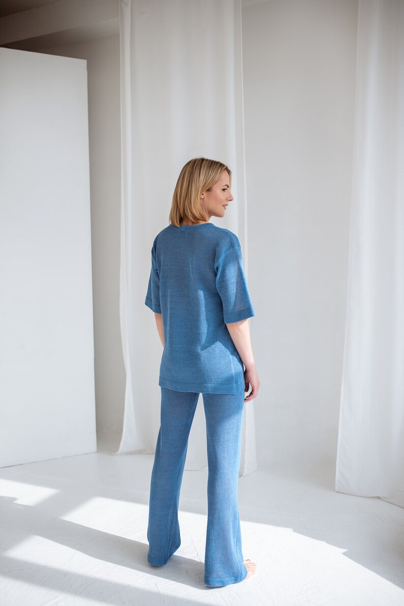 Minimalist, see-through linen blouse in light blue. Comfortable, sophisticated fit for every summer occasion.