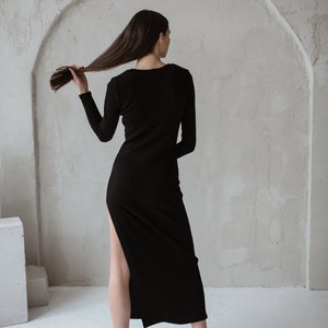 Black merino wool dress with a long hem and long sleeves