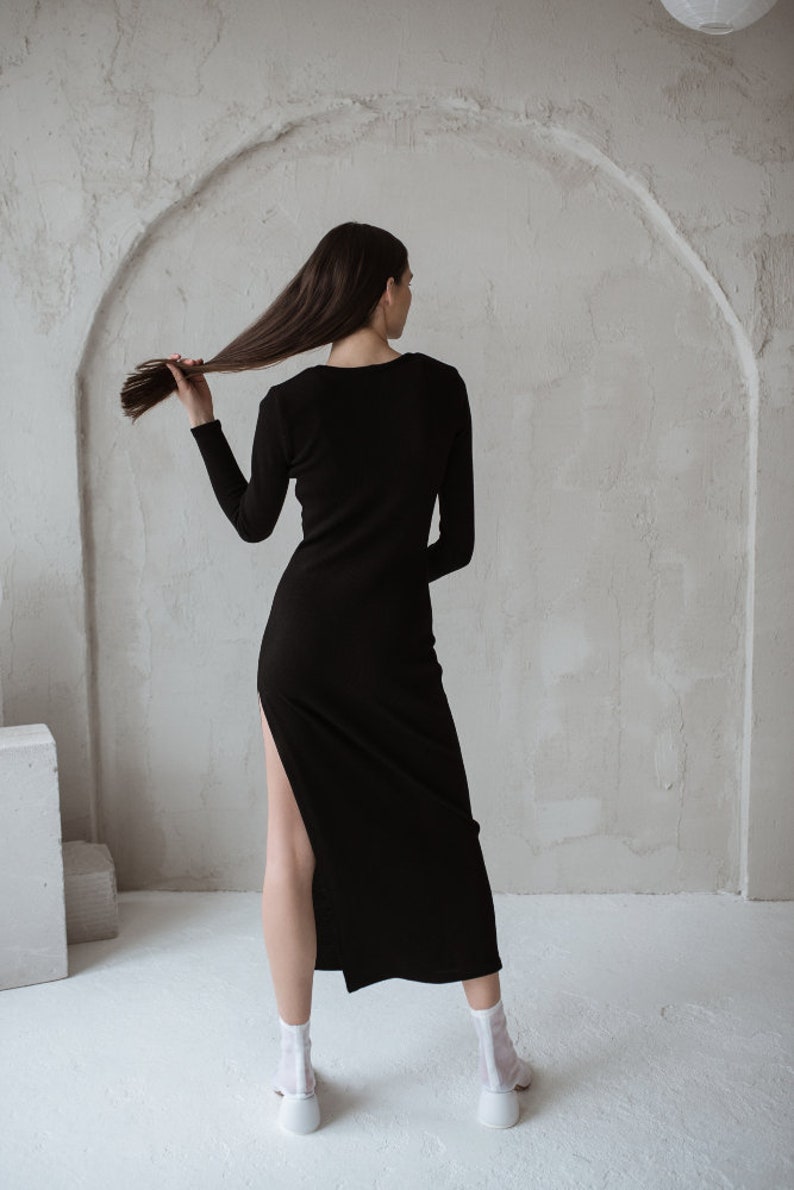 Black merino wool dress with a long hem and long sleeves