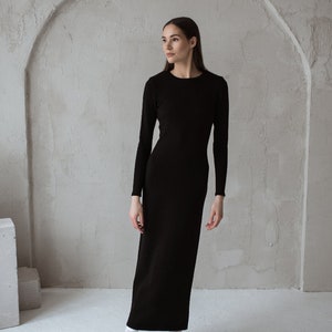 Minimalist black merino wool dress with a side slit