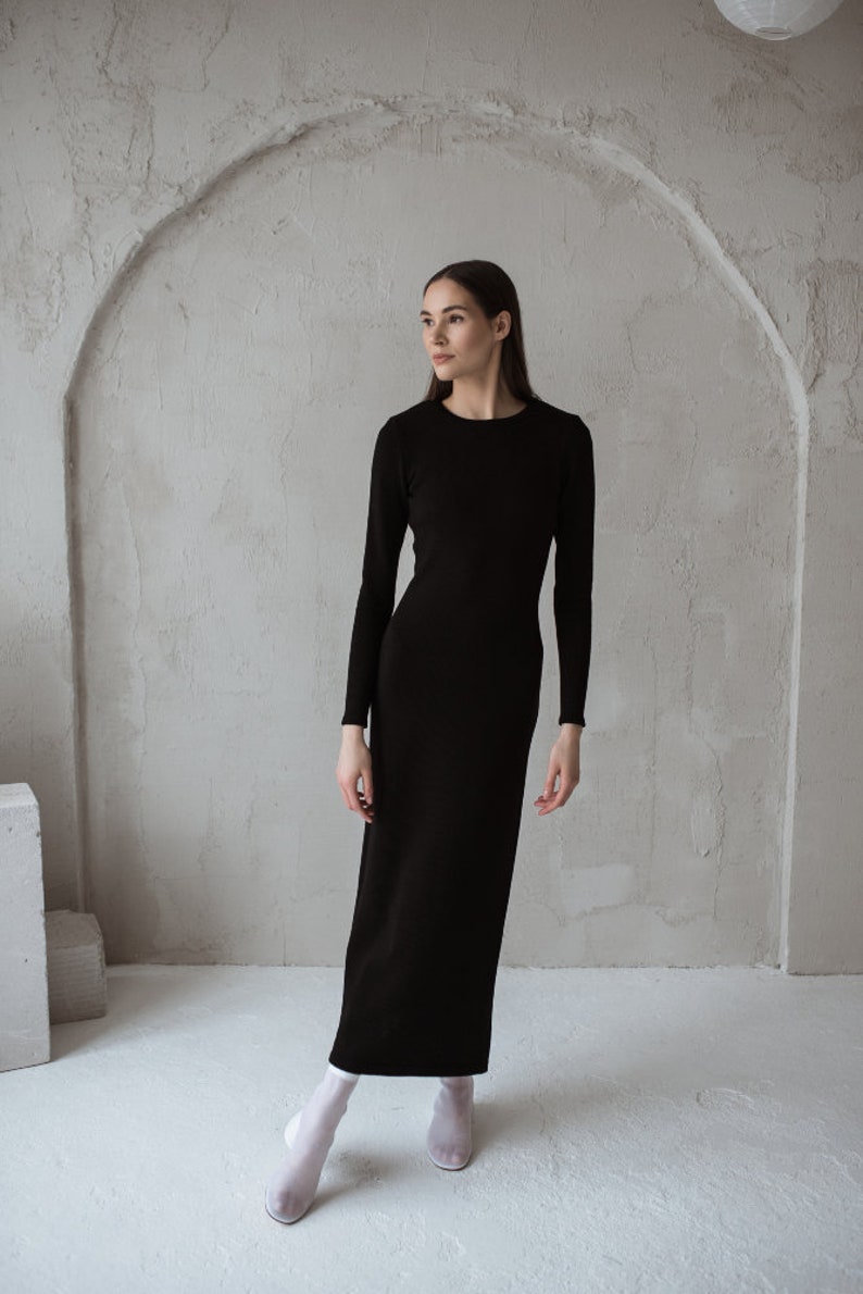 Minimalist black merino wool dress with a side slit