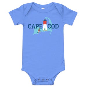 May include: A light blue baby onesie with a white outline of Cape Cod and a red and white lighthouse. The text "CAPE COD" is printed in navy blue.