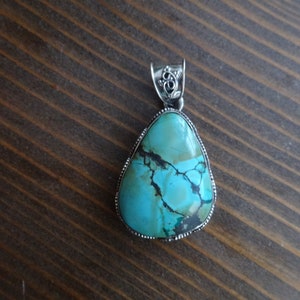 Turquoise pendant with detailed sterling silver