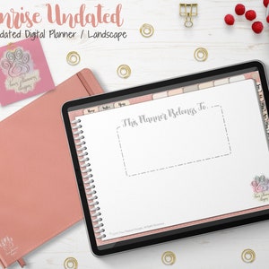 Puede incluir: Un planificador digital con el texto "Sunrise Undated" y "This Planner Belongs To" en la pantalla. También se ven un cuaderno rosa encuadernado en cuero y una nota adhesiva rosa con un diseño de huella de pata. Clips dorados y un cuenco de frambuesas.