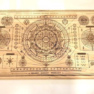 May include: A wooden board with intricate etched designs, featuring geometric shapes, diagrams, and text. The board includes the text "Harmonic Machine Interface" and "Balance - Harmony - Resonance". Decorative corner accents are visible.
