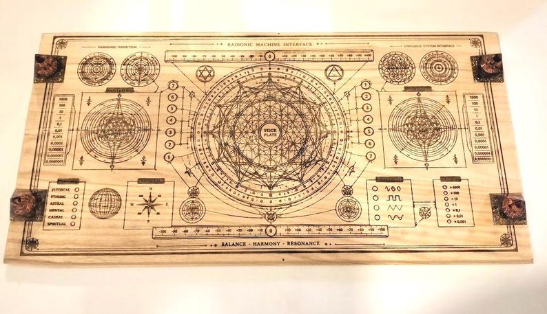 May include: A wooden board with intricate etched designs, featuring geometric shapes, diagrams, and text. The board includes the text "Harmonic Machine Interface" and "Balance - Harmony - Resonance". Decorative corner accents are visible.