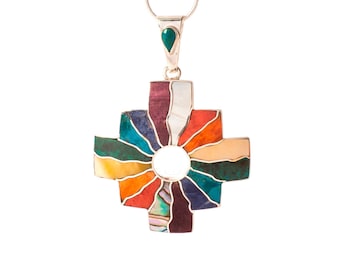May include: A silver pendant necklace with a colorful cross design. The cross is made of various stones, including turquoise, red, orange, yellow, and green. The pendant is attached to a silver chain.