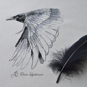 May include: Black and white cross-stitch embroidery of a crow in flight with a black feather below. The embroidery is signed "Elena Lyubimova".
