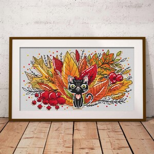 May include: A black cat with green eyes sits in a pile of colorful autumn leaves. The leaves are red, orange, and yellow. There are also some red berries in the image.
