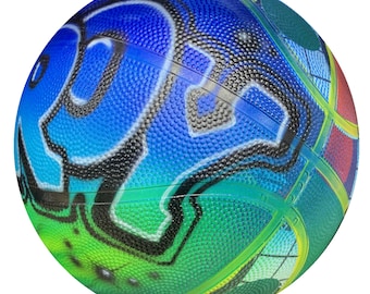 May include: A blue, green and black basketball with a graffiti-style design. The basketball has a textured surface and a black outline.