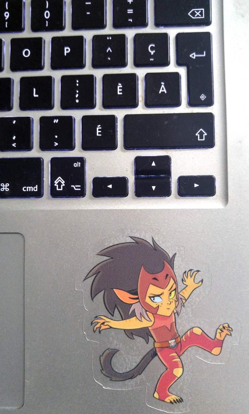 May include: A sticker of a cartoon character with red, yellow, and black hair, wearing a red and yellow outfit, with a red and white belt, and a red and white headband. The character is in a fighting pose with one leg raised and one arm extended.