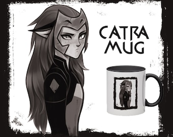 May include: A black and white illustration of a character from the animated series She-Ra and the Princesses of Power. The character is Catra, a fierce warrior with a determined expression. The illustration is printed on a white ceramic mug with a black rim and handle. The text "CATRA MUG" is printed in black above the mug.