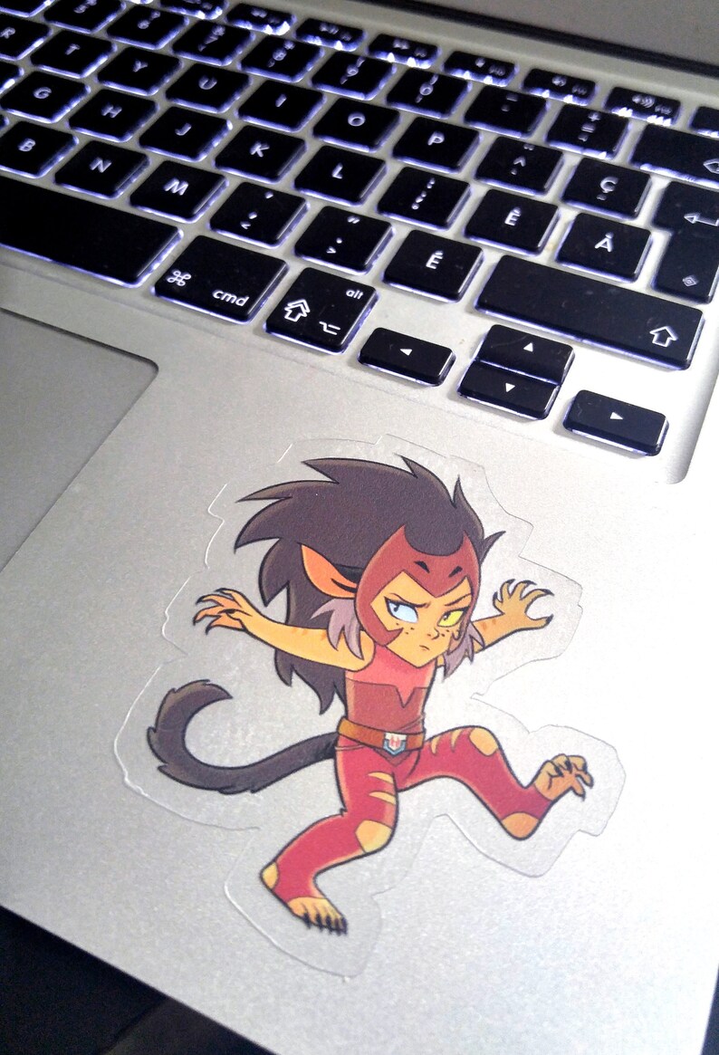 May include: A sticker of a cartoon character with red hair, a red and yellow outfit, and a black tail. The character is in a running pose with one arm raised and the other arm extended.