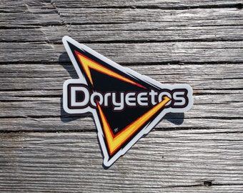 May include: A white sticker with a black triangle and yellow lightning bolts. The text "Doritos" is written in red and white letters inside the triangle.