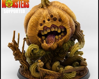 May include: A 3D printed pumpkin monster with a toothy grin, five eyes, and a long tongue. The monster is surrounded by vines and has a wooden fence at its base. The base is a round, black platform. The text "PRINT YOUR MONSTERS SUPPORTED" is visible in the top left corner of the image.