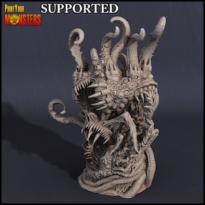 May include: A detailed, beige-colored monster sculpture with multiple eyes, sharp teeth, and tentacles. The sculpture has the text "Print Your Monsters" and "Supported". The creature has a complex, textured surface.