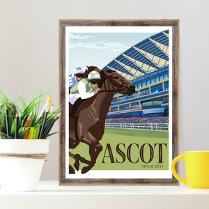 May include: Framed print featuring a horse race scene at Ascot. The artwork depicts a jockey on a brown horse, racing past a grandstand. The print has a vintage style with the word "ASCOT" and "SINCE 1711" in a serif font.