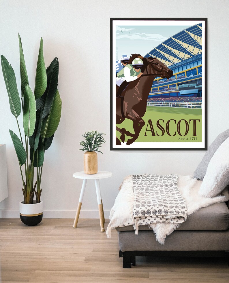 May include: A framed poster featuring a horse race scene at Ascot. The artwork depicts a brown horse with a jockey in green and white racing attire. The background shows a grandstand and the text "ASCOT SINCE 1711".
