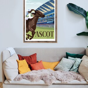 May include: A framed art print featuring a horse race scene at Ascot. The illustration depicts a brown horse with a jockey in green and white racing attire. The word "ASCOT" is prominently displayed, with "SINCE 1711" below.