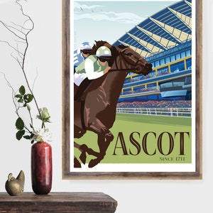 May include: A framed print featuring a horse race at Ascot. The artwork depicts a brown horse with a jockey in green and white racing past a grandstand. The word "ASCOT" is prominently displayed, with "SINCE 1711" below.