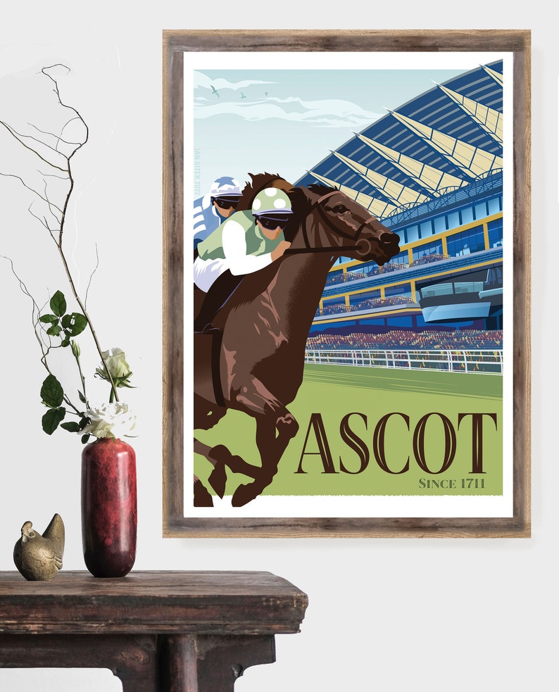 May include: A framed print featuring a horse race at Ascot. The artwork depicts a brown horse with a jockey in green and white racing past a grandstand. The word "ASCOT" is prominently displayed, with "SINCE 1711" below.