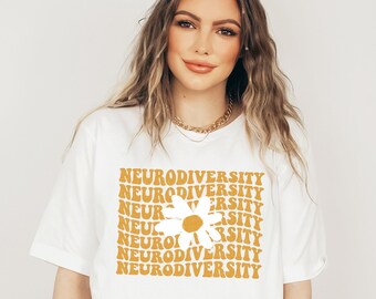 May include: White t-shirt featuring a yellow daisy graphic and the text "Neurodiversity" repeated in a retro font.