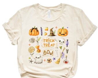 May include: A beige t-shirt with a Halloween-themed design featuring pumpkins, ghosts, candy, and the text "Trick or Treat Boo!"