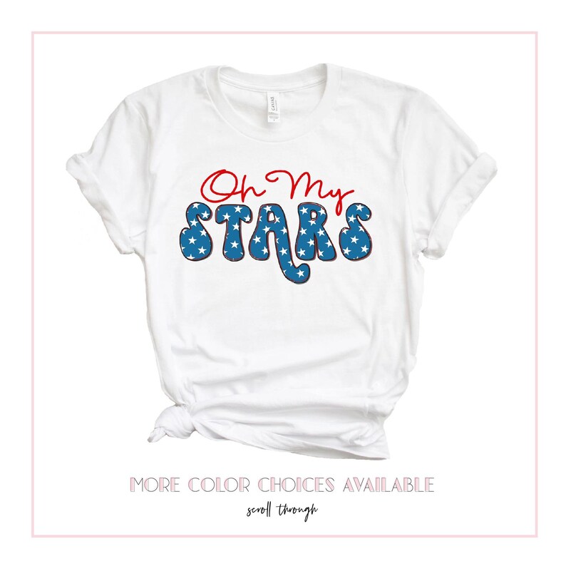 May include: White t-shirt with red and blue text that says "Oh My Stars". The text is in a retro font and has a blue and white star pattern.
