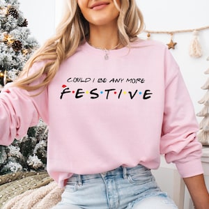 a woman wearing a pink sweatshirt that says i could't be any more fest