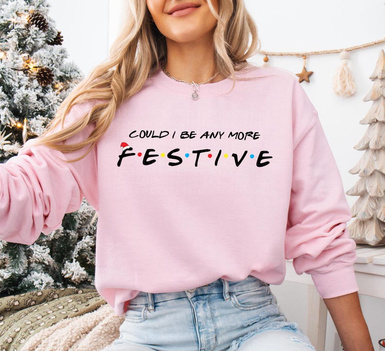 a woman wearing a pink sweatshirt that says i could't be any more fest