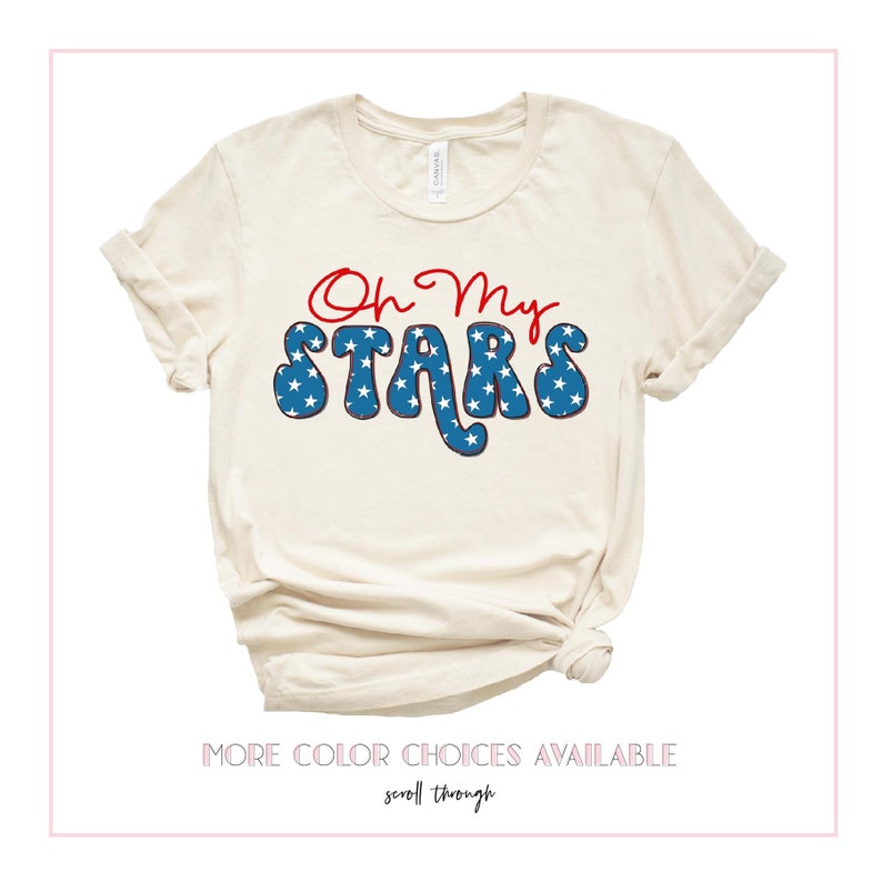 May include: A beige t-shirt with the text "Oh My Stars" in red and blue. The text is in a retro font and features white stars on a blue background.