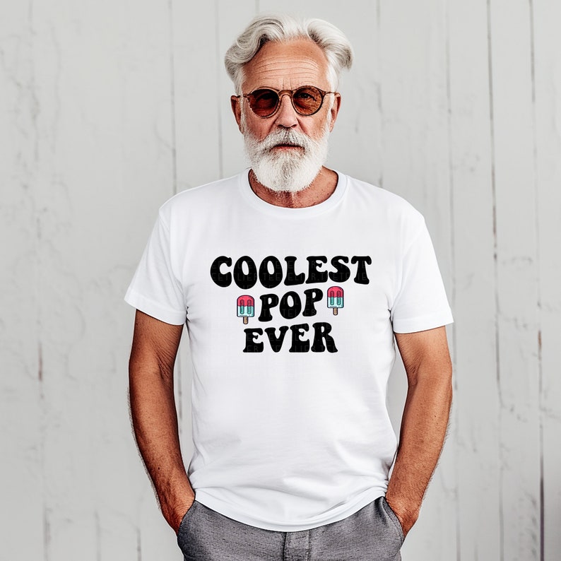 May include: White t-shirt with black text that reads "Coolest Pop Ever" and two cartoon popsicles on either side of the word "Pop".