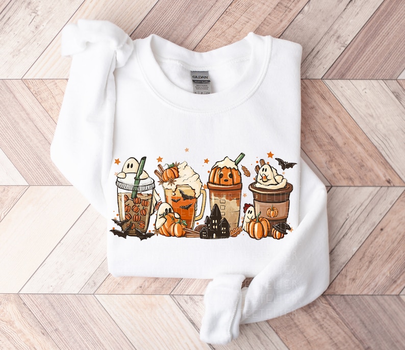 May include: White sweatshirt with a graphic of pumpkin spice lattes and ghosts. The graphic includes the text "BOO!"