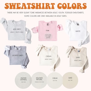 May include: A chart showing the different color options for sweatshirts. The colors include ash grey, sports grey, cream, sand, pink, white, heather oatmeal, and heather natural. Some colors are only available in adult sizes.