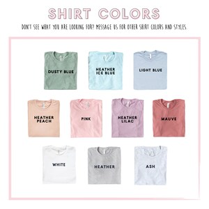 May include: A selection of t-shirt colors, including dusty blue, heather ice blue, light blue, heather peach, pink, heather lilac, mauve, white, heather grey, and ash.