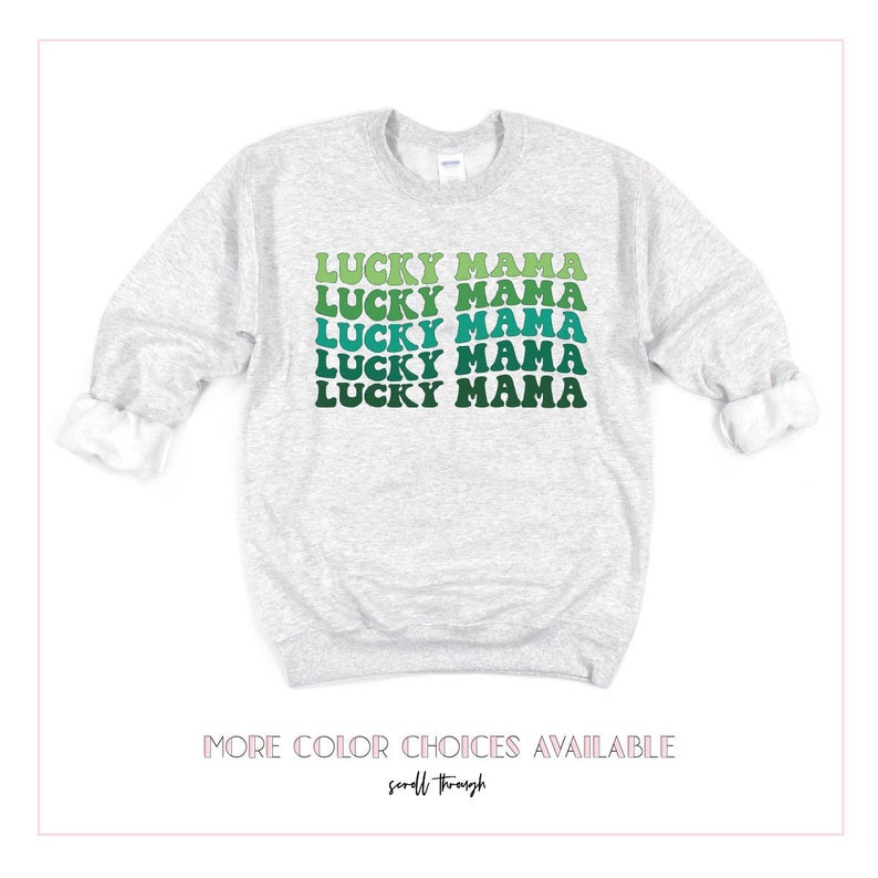 May include: A gray sweatshirt with the text "LUCKY MAMA" repeated five times in a green, blue, and white gradient. The text is in a retro font style.