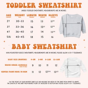 May include: A chart with size measurements for toddler and baby sweatshirts. The chart shows the age, weight, length, width, and sleeve length in inches. The chart is on a peach background with a white border. The chart is next to a picture of a gray sweatshirt.