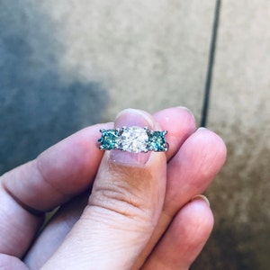 Three Stone Moissanite Engagement Ring: White & Greenish Blue, Sterling Silver