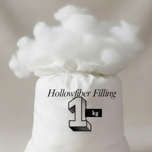 May include: A white bag of hollowfibre filling, with a fluffy cloud of the material spilling out the top. The bag has the text "Hollowfibre Filling" and the number "1" with "kg" next to it.
