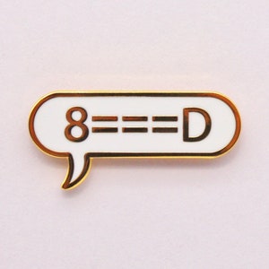 May include: Gold-colored enamel pin with a white speech bubble that says "8===D".